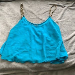 Blue crop top with black and gold straps